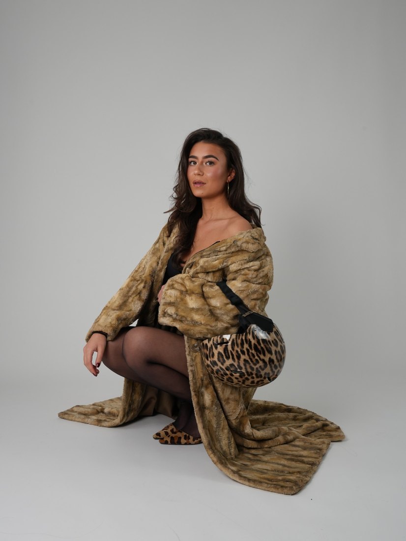 Lulu Bos in a leopard-print helmet and faux-fur coat